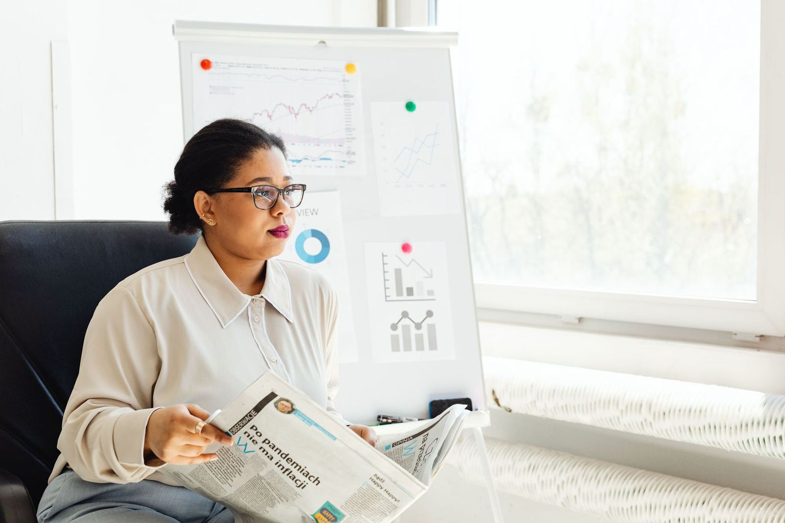 Analyst reviewing research data and charts